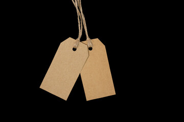 2 blank tags with twine on black background