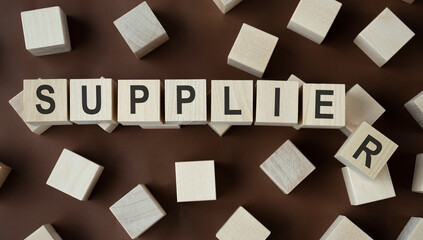 SUPPLIER word written on wood block. SUPPLIER text on wooden table for your desing, concept.
