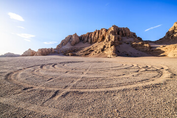 Obraz premium Desert sand road and mountain natural landscape in Xinjiang, China. Road trip in no man's land.