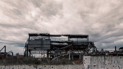 Fototapeta premium destroyed and burned factory buildings in the city in Ukraine