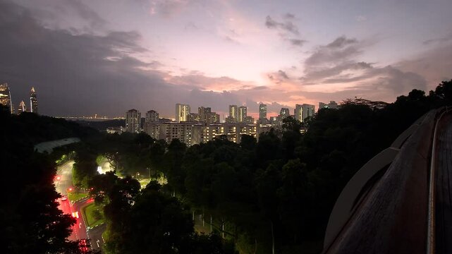 The Henderson Wave Pedestrian Bridge. View of Singapore's beautiful downtown at night.