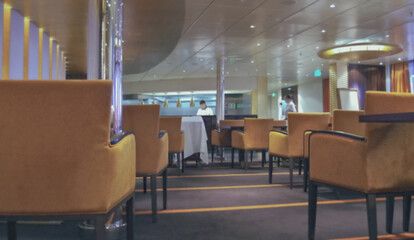 Formal and elegant Art Deco steak house dining room restaurant onboard luxury cruiseship or cruise...