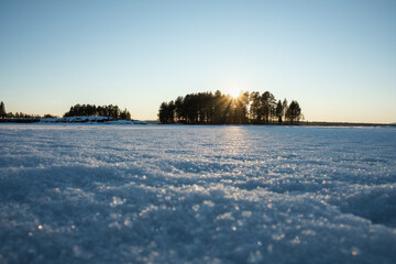 Snow-covered landscape in Leksand Dalarna Sweden during winter with a sunset glow