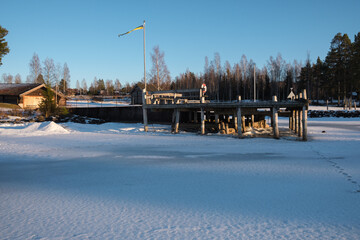 Winter dock by the frozen lake in Leksand, Dalarna, Sweden