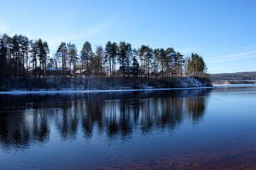 Beautiful winter landscape in Leksand, Dalarna showcasing tranquil lake reflections