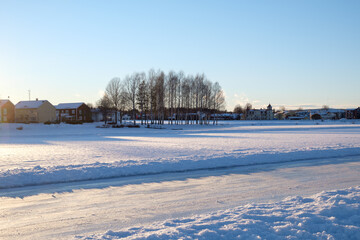 Winter landscape showcasing snow-covered fields and trees in Mora, Dalarna, Sweden