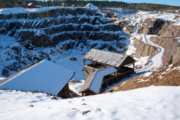 Winter landscape of Falun Mine with snow-covered structures in Dalarna, Sweden