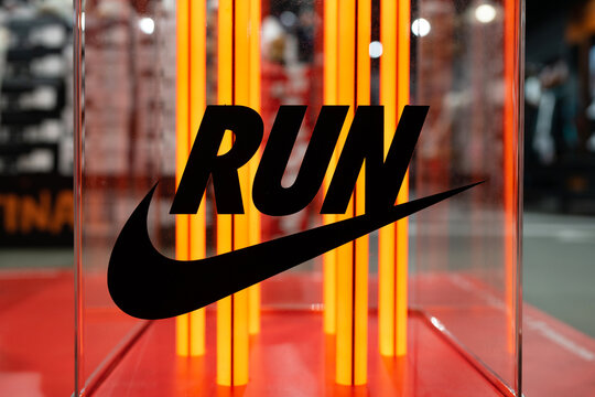 NIKE logo. Neon Nike logo in the interior of the Nike brand store. Nike Run Sign. Minsk, Belarus - December 5, 2024
