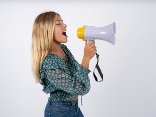 Beautiful teen girl wearing green fashion T-shirt Through Megaphone with Available Copy Space