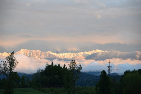 snowy mountains againt cloudy sky