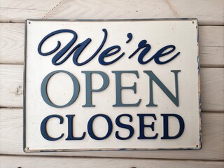 Vintage Style 'WE'RE OPEN CLOSED' Sign for Shops, Cafes, Bars, and Restaurants with Modern Calligraphy Typography and Beveled 3D Letters in Minimalist Photography