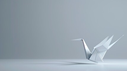 Naklejka premium A minimalistic origami crane on a solid light gray background.