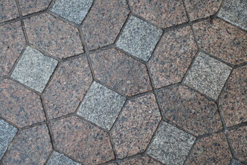Obraz premium Macro of wet red and grey unpolished granite pavement