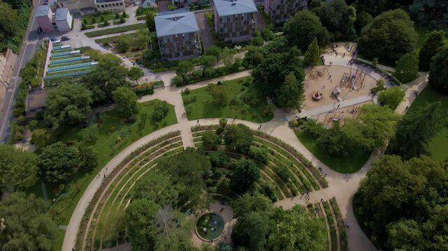 Sideway upwards drone movement about the Parc du Thabor spiral garden and its closest environment, Rennes, France.