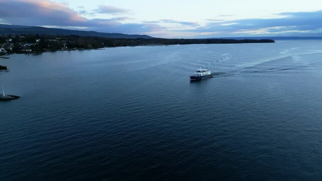Parallax drone shot of boat sailing on Lake Geneva near Nyon in Canton of Vaud Switzerland