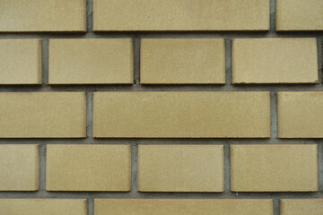 Texture of pale yellow smooth brick wall with English bond