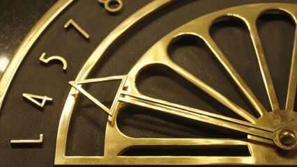 Close up view on Antique bronze dial indicator for the movement of the elevator cabin
