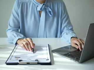 Asian businesswoman employer sitting holding new employee's documents to evaluate and review new...