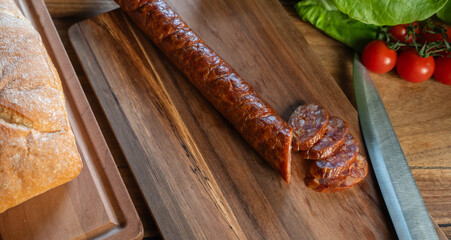 Fototapeta premium A composition of vegetable and sausages on the table