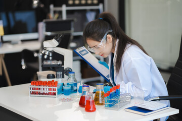 Science and medicine, scientist analyzing and dropping a sample into a glassware, experiments...