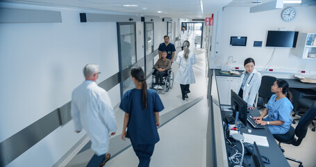 High Angle CCTV Shot with a Busy Hallway with Reception Desk of a Hospital Building, Diverse Female...