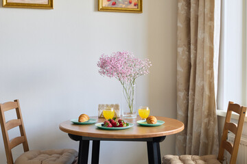 Charming and Inviting Breakfast Table Setup Featuring Fresh Fruits and Beautiful Flowers