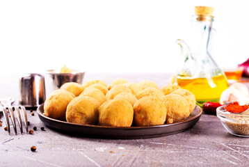 Fresh falafel balls on a black plate
