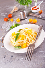 Pasta with cherry tomatoes o white plate