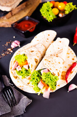 Shawarma sandwich, fresh roll of lavash (pita bread) pork shawarma with ham and cheese