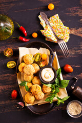Fork with delicious falafel balls, sauce and vegetables on grunge background