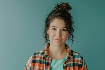 Portrait of a merry caucasian woman in her 30s wearing a comfy flannel shirt on solid color backdrop