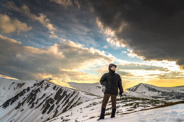 Serene man with a beard and curled mustache gazing at scenic view of snow-covered mountains at...