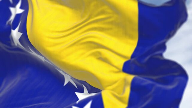 Close-up of Bosnia and Herzegovina national flag waving in the wind