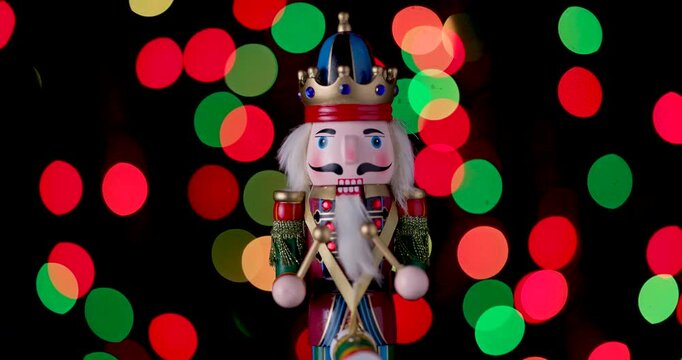 Nutcracker Wooden Soldier Toy against bokeh of festive vintage backdrop Christmas lights video