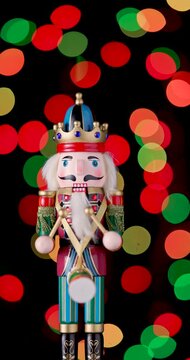 Nutcracker Wooden Soldier Toy against bokeh of festive vintage backdrop Christmas lights video