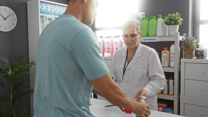 Fototapeta premium Pharmacist woman assisting man in pharmacy interior with various healthcare products on shelves
