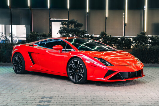 Photo of a red Lamborghini Gallardo LP560-2 50th Anniversary. The night photo with light painting is suitable for use in marketing materials, advertisements or press articles.