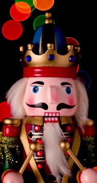 Nutcracker Wooden Soldier Toy against bokeh of festive vintage backdrop Christmas lights video