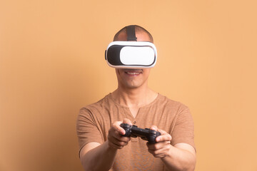 happy bald man playing videogame with VR headset in studio shot. virtual reality, gaming, leisure concept.