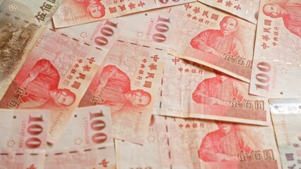 Chinese yuan banknotes spread out, showcasing various denominations and vibrant details of chinese currency.