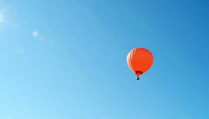 Fototapeta premium Red hot air balloon against clear blue sky