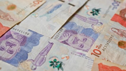 Close-up of colombian pesos banknotes, showcasing colorful currency notes from colombia in various...