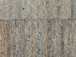 Obraz premium composite fence made of narrow stained boards with a unique beautiful texture, wooden plank background with a smoothed blurred natural wood pattern