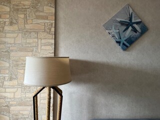 Elegant Cream Floor Lamp and Wallpaper with a Touch of Blue Artwork for a Stylish Interior