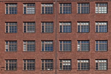 Fototapeta premium Windows on a red brick wall.