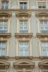 Vienna, Austria - May 12, 2019: Windows of beautiful palace, closeup photo. Ancient architecture of residential buildings. European architecture of buildings and apartments.
