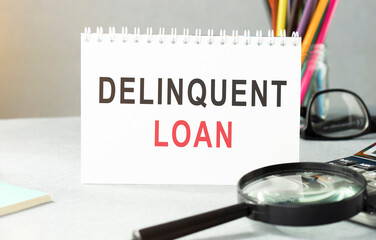 Delinquent loan is shown on the conceptual business photo.