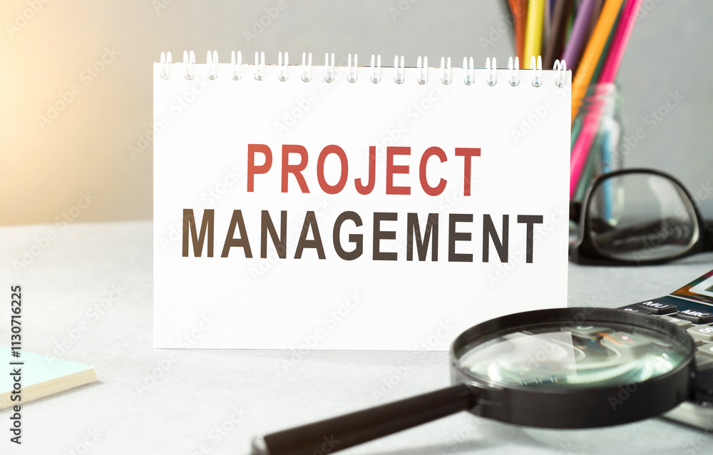 Poster project management memo written on a notebook with pen