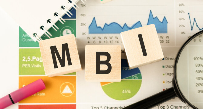 Text MBI on wooden cubes on a wooden background