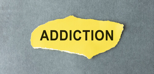 Card with text ADDICTION, pills and syringe. Medical concept.